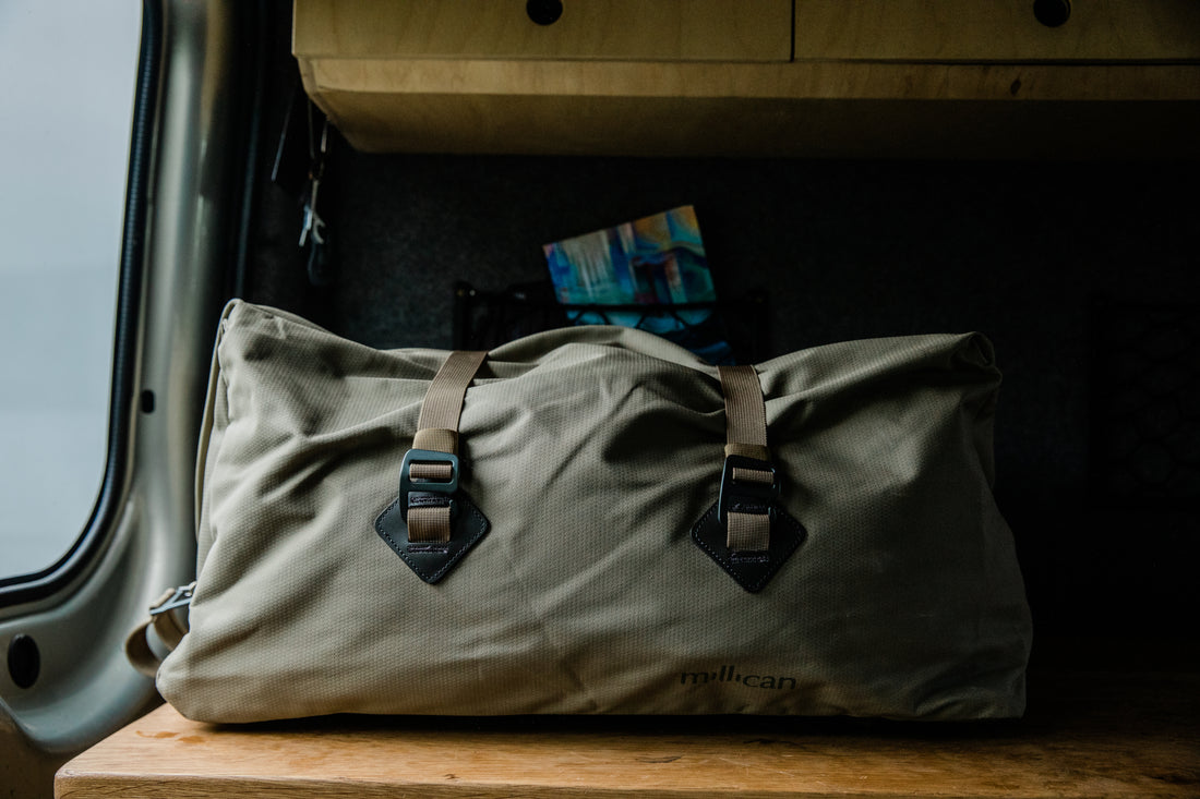 Millican bag on a wooden surface in a van interior