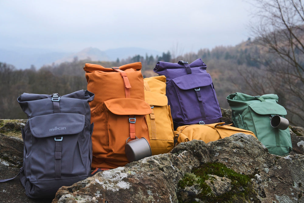 Collection of colourful backpacks on a rock
